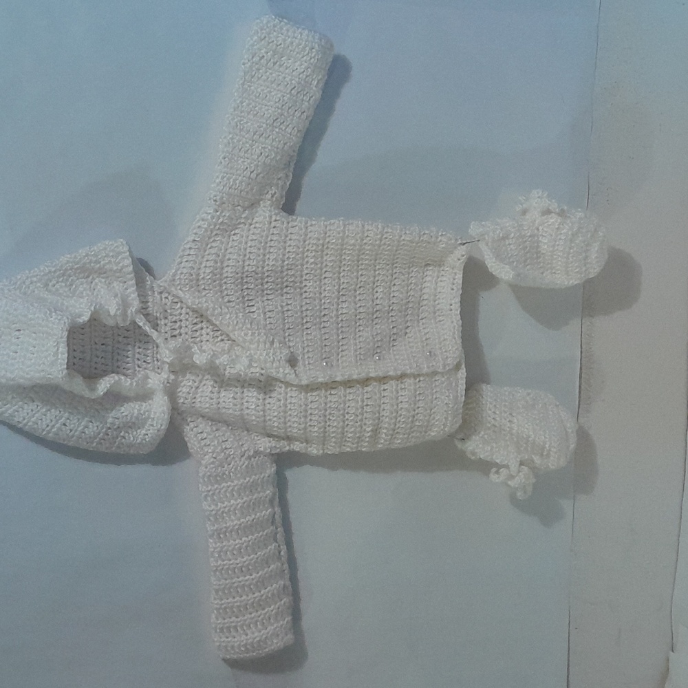 A white christening baby hoodie .